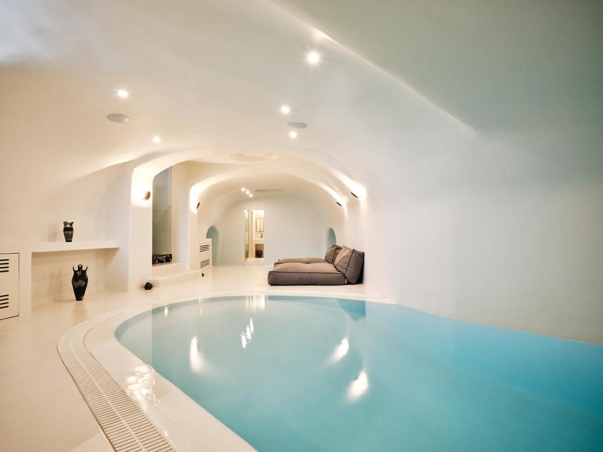 Indoor pool area with lounges at the Abyss, Oia